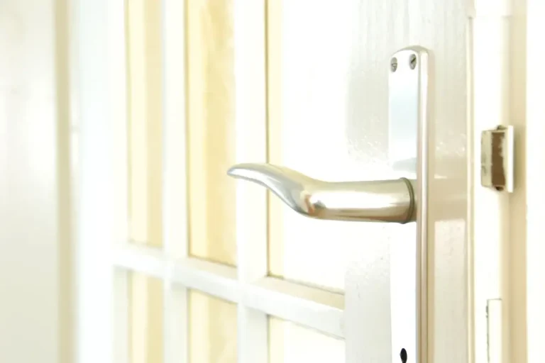 How to change a uPVC door lock in Boston – white door with a lever handle on a long backplate, Locksmith Boston guide to barrel, handle and multipoint replacement