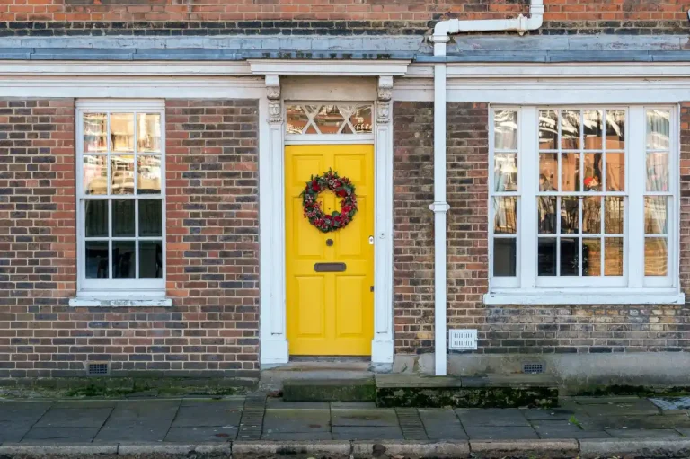 Types of door locks in the UK – yellow front door on a red-brick Victorian house in Boston, Locksmith Boston guide to identifying your lock